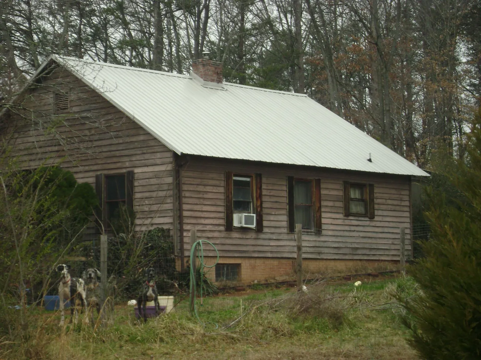White metal roof on an old wood sided farmhouse, from a Metal Roof Installation job in King William